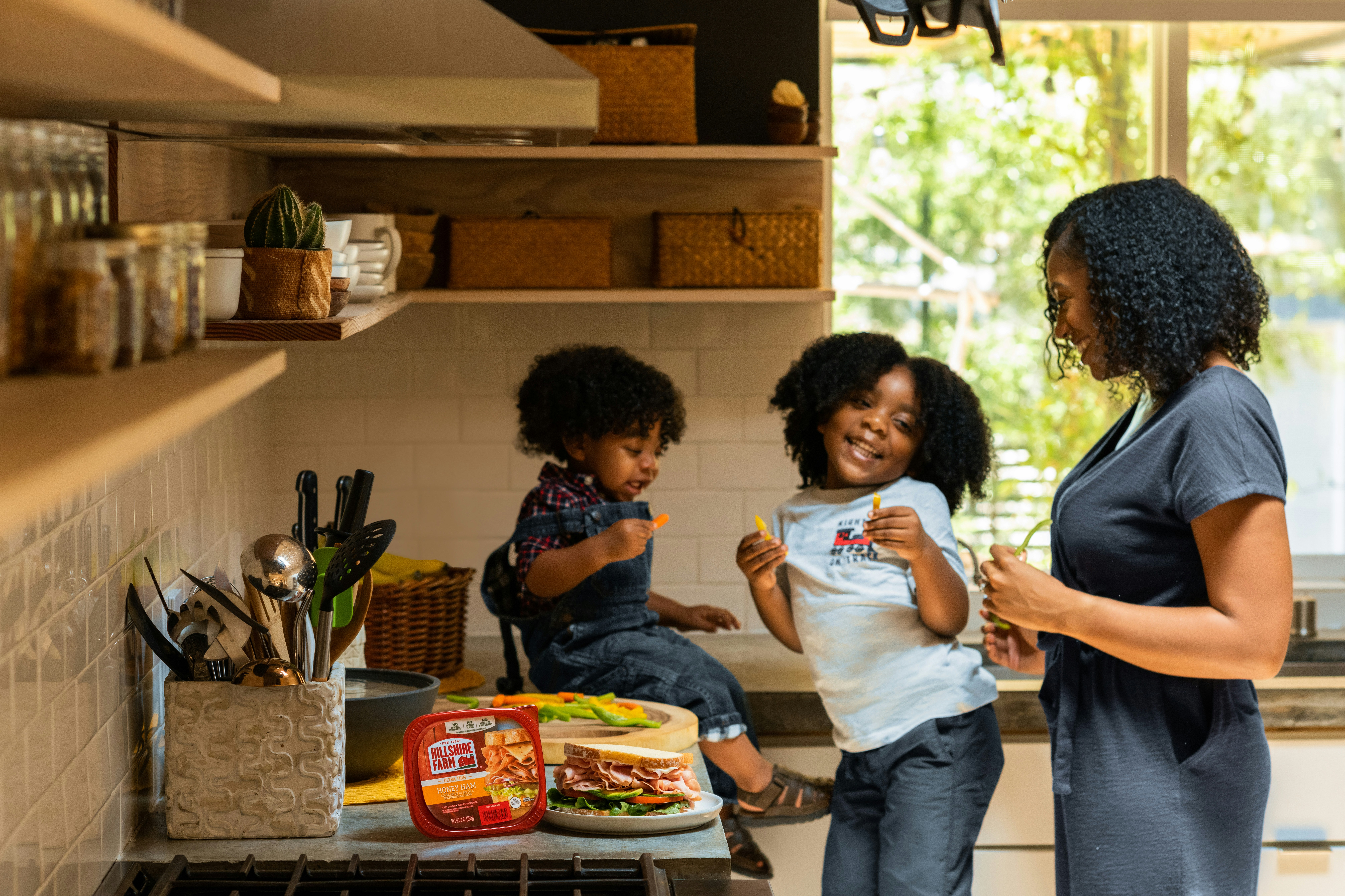 Happy family in the kitchen. Mother and children with meal.